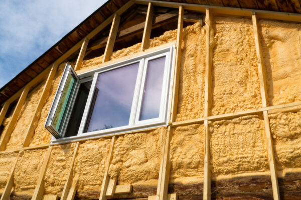 exterior home window with foam sprayed in walls