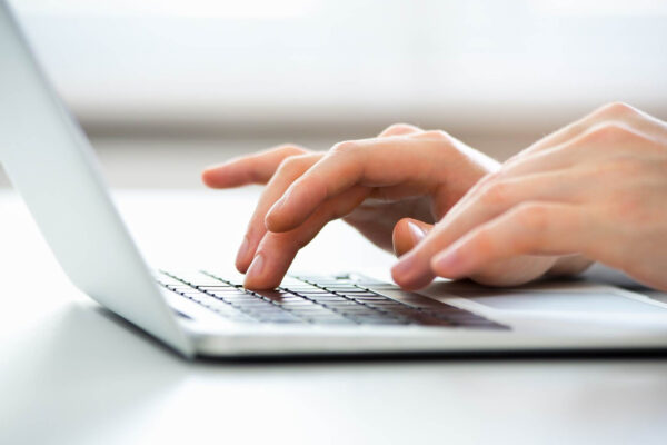 person typing on laptop